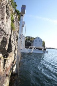 Aluminum IMM Quality boat lift with specialty lift installed into the side of a sheer cliff