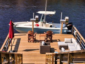 A large residential dock with the Alumavator elevator lift stores a high speed boat