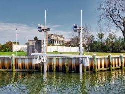 elevator boat lift attached to seawall of waterfront residential home