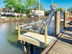 kitzen elevator alumavator highspeed boat lift mounted to dock on canal